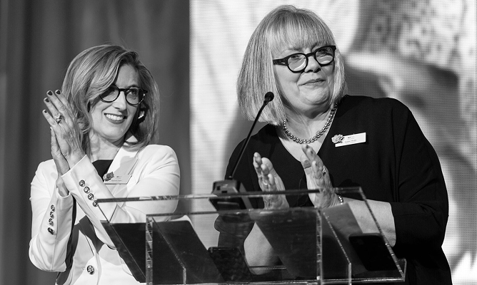 women applauding at an event